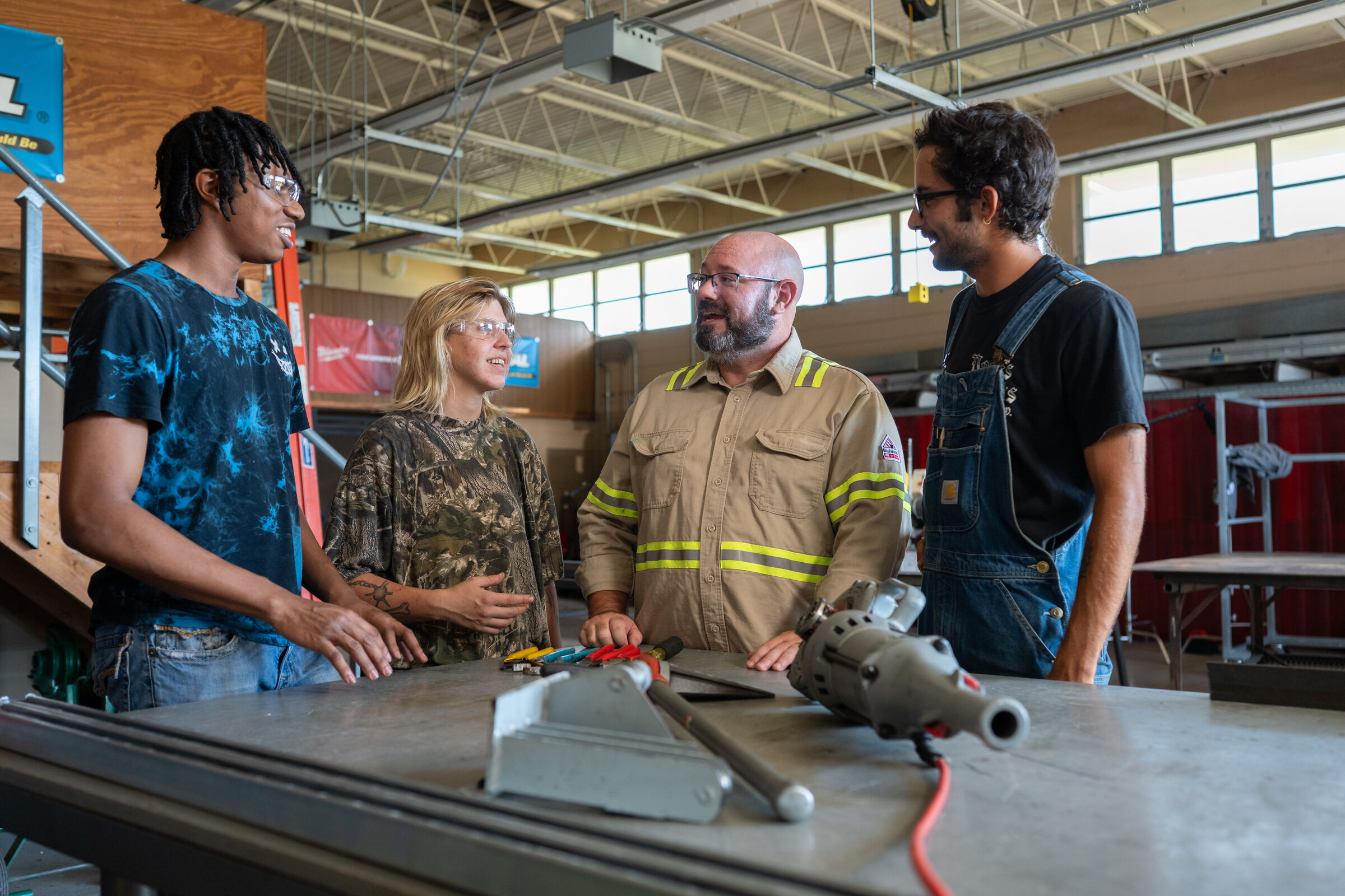 Brian Nathan speaking with a group of workers at an electrical training center