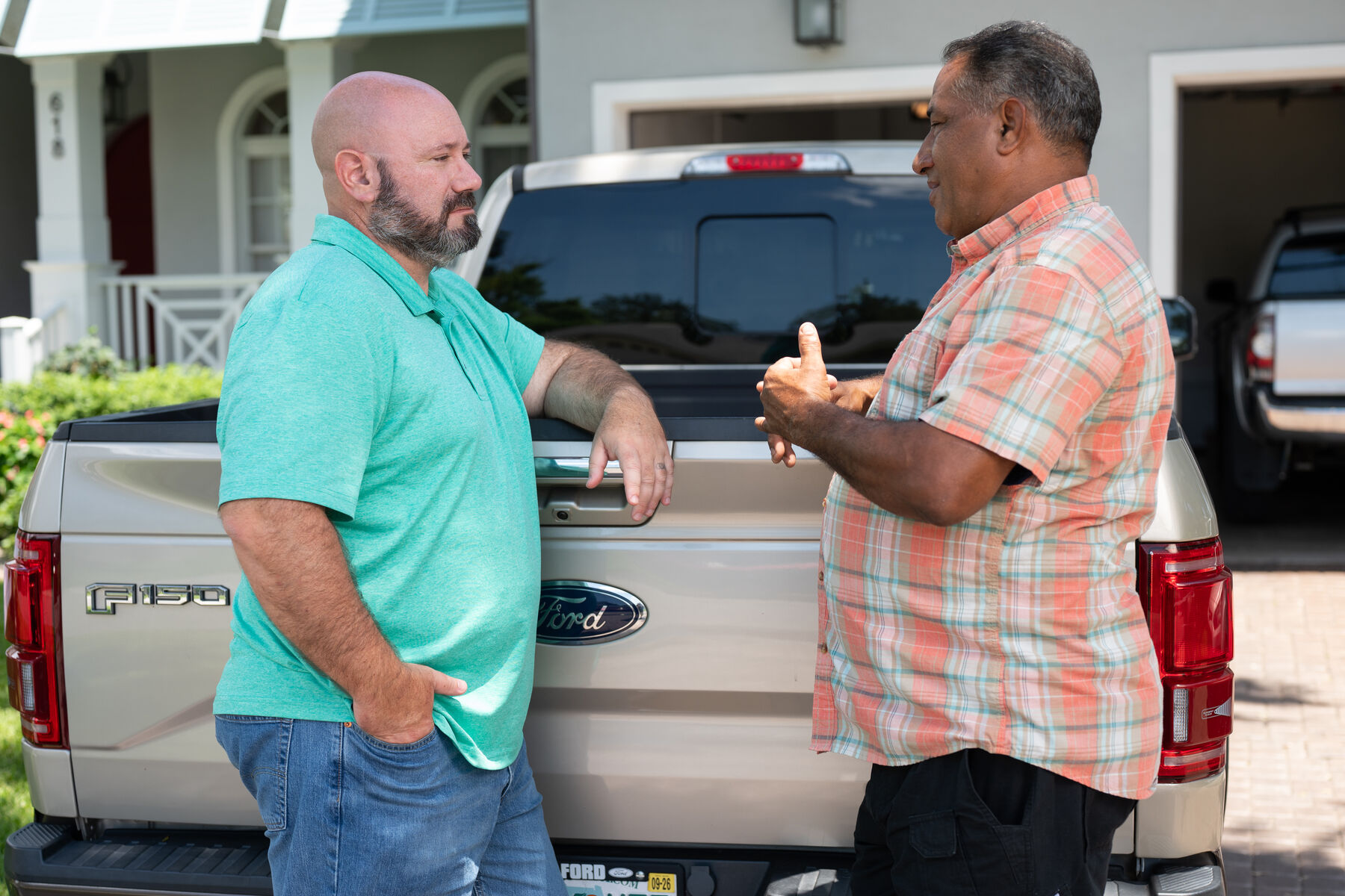 Brian Nathan talking with a Tampa resident in his driveway