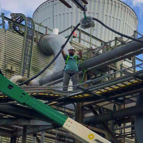 Brian Nathan on an industrial job site, high on a plant structure